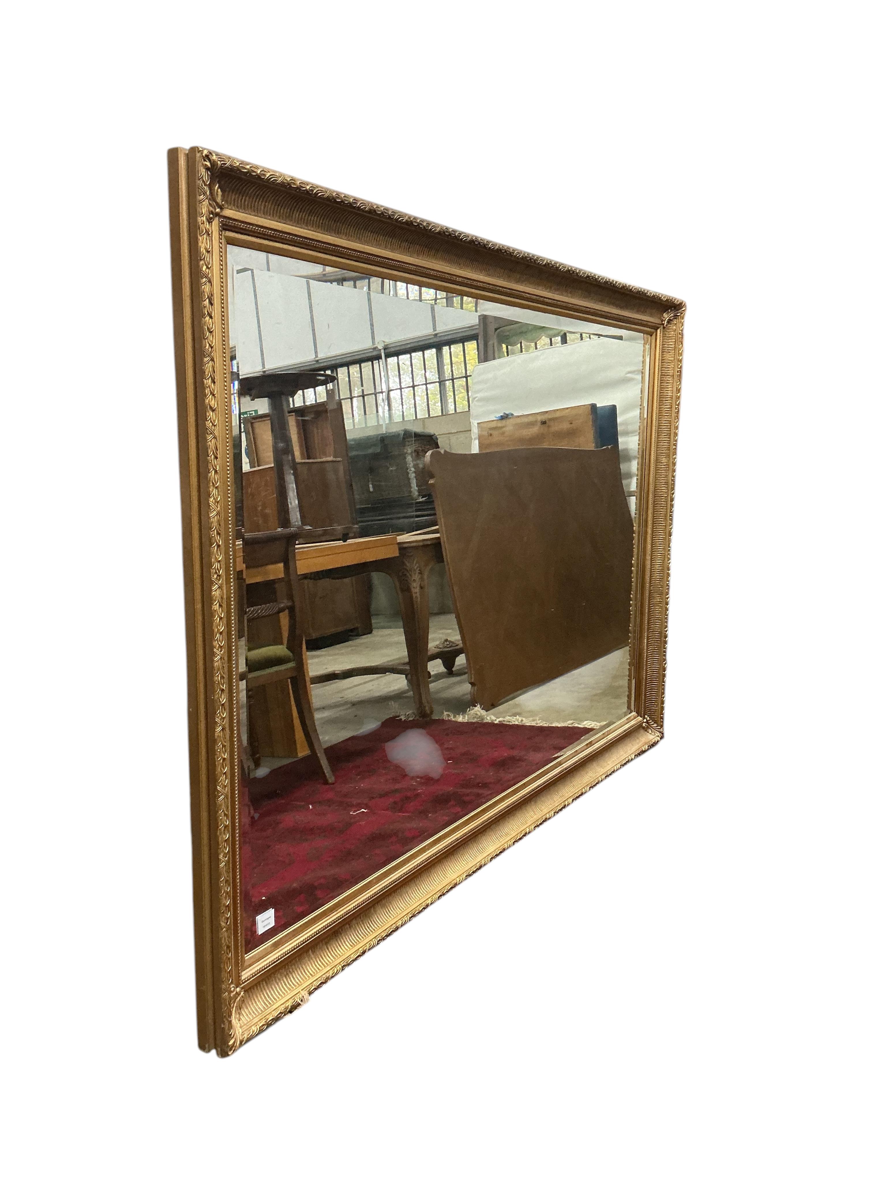 A large Victorian style rectangular gilt composition wall mirror, width 204cm, height 142cm